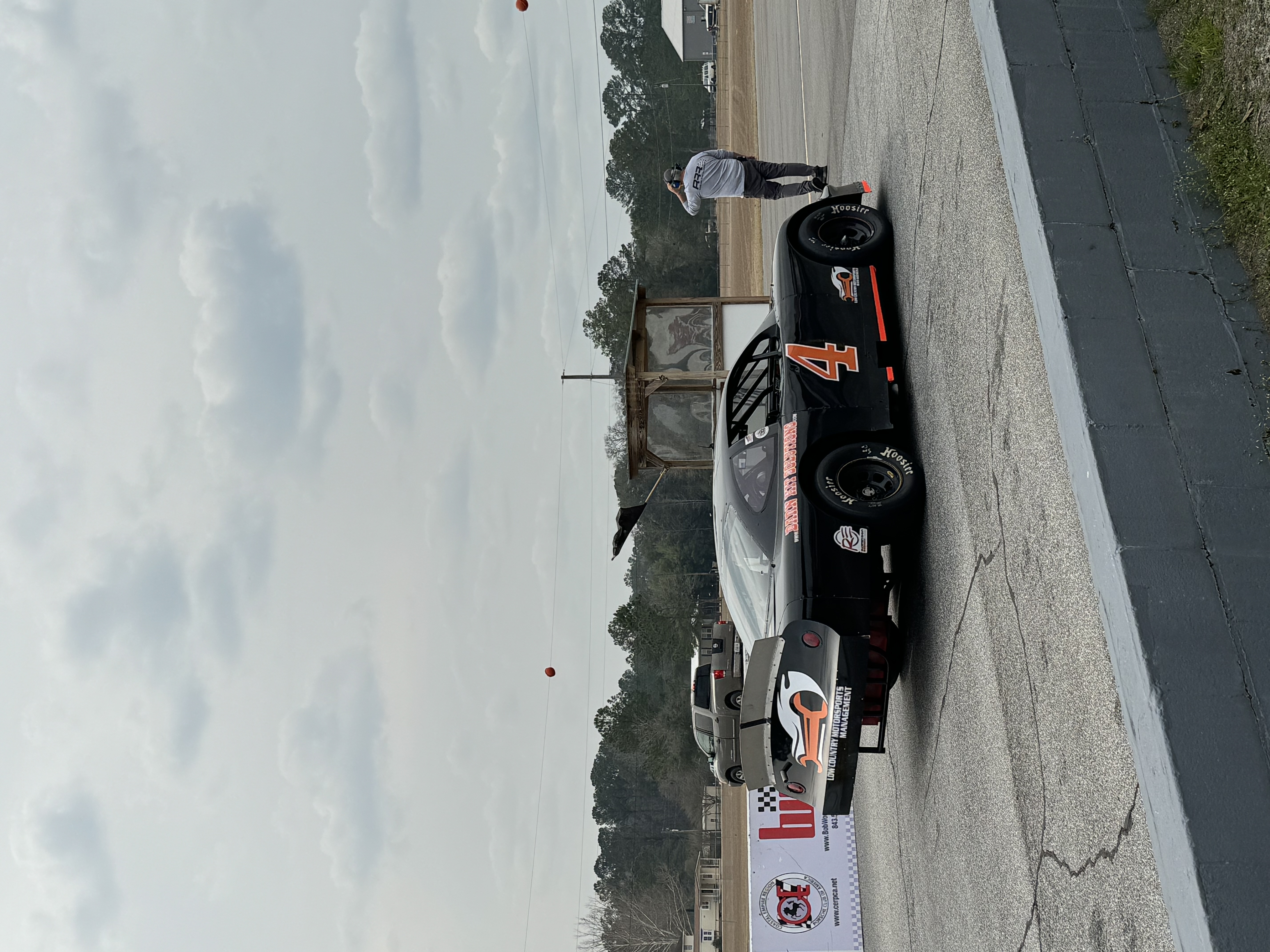 The No. 4 Low Country Motorsports car on track past a corner worker