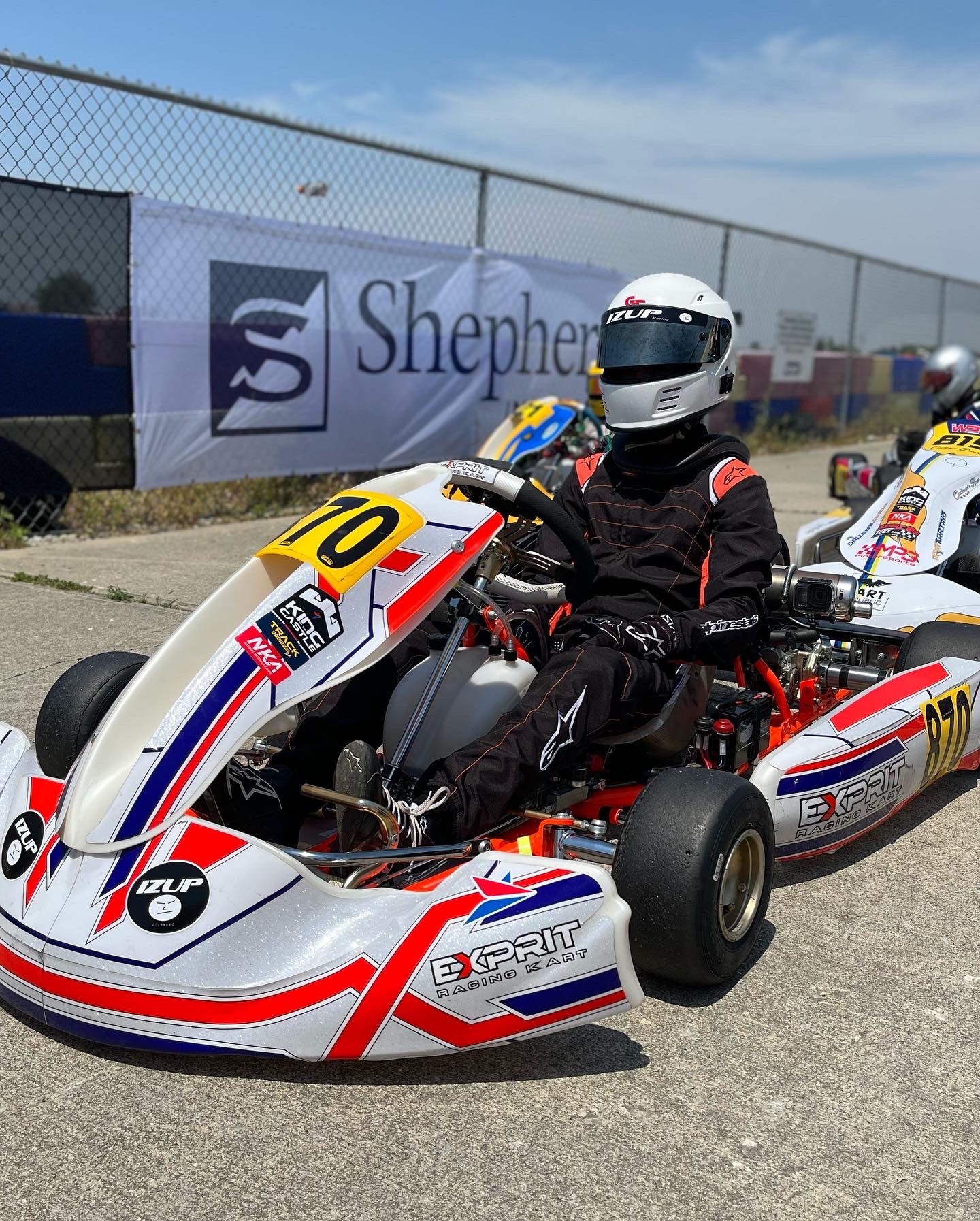 Hayden in his kart on track in front of a Shepherd sponsor banner